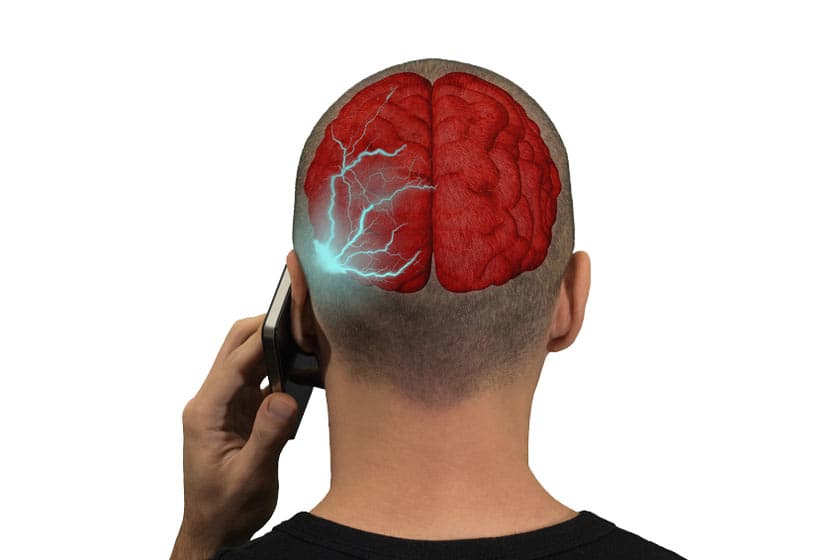 Un jeune tient un téléphone portable à l'oreille
